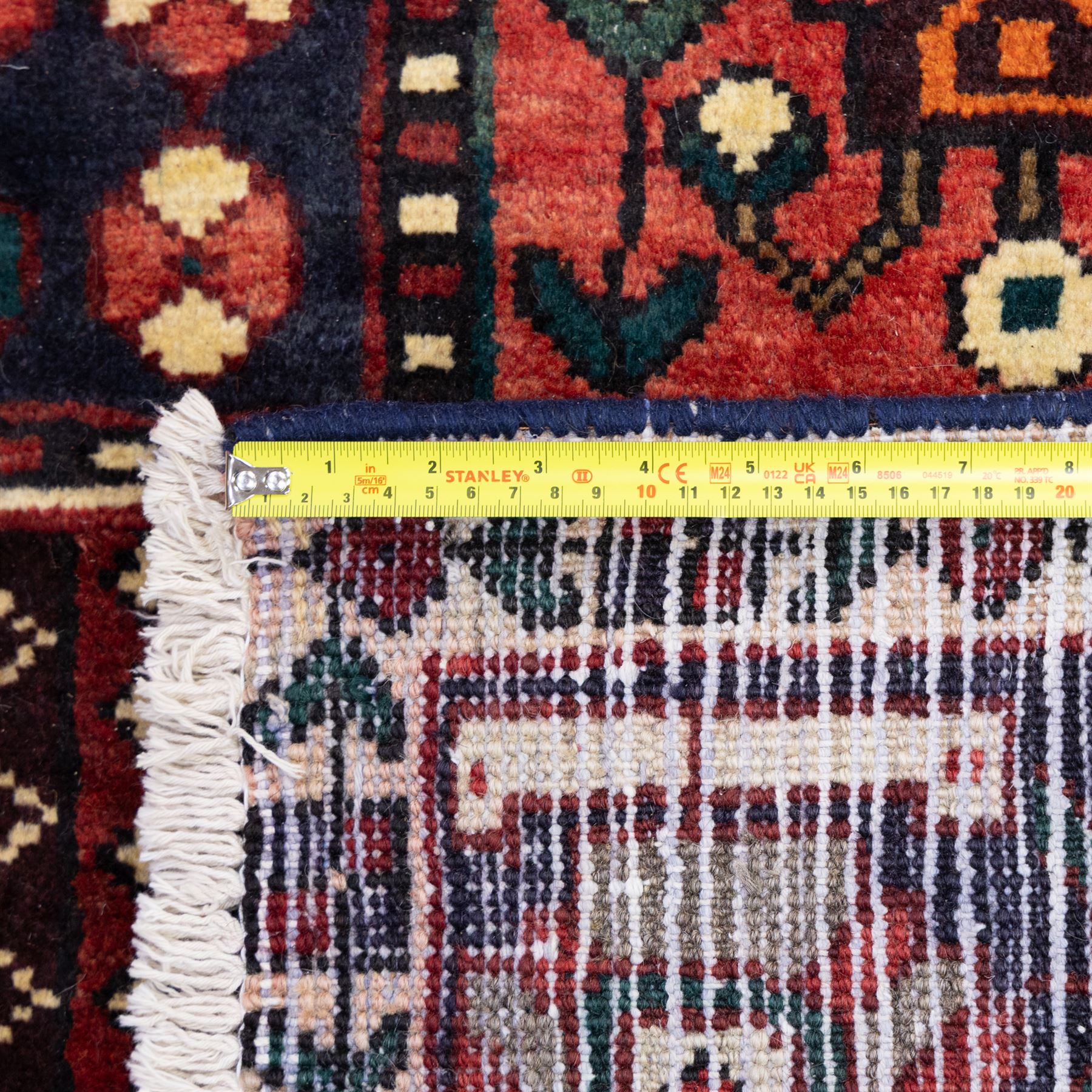 Bakhtiari wool rug, compartmented garden design field with panels of stylised trees, flowers and geometric motifs, enclosed by dark blue main border with repeating floral medallions and guard stripes