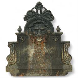Victorian cast iron ‘lavabo’ lion's head wall fountain, the arched and crested backplate centred with a lion's head spout, with flanking scroll columns and gadrooned basin with flared rim

