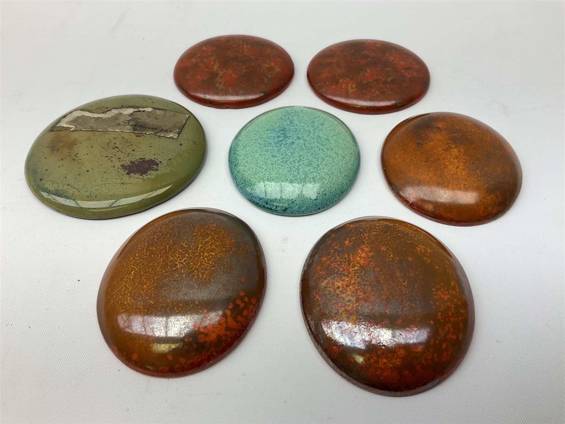 Henry George Murphy (1884-1939), collection of seven Arts & Crafts glazed ceramic roundels, of circular and oval form, five in tones of red and brown and two in tones of blue, turquoise and green in soufflé and high fired finishes, largest example D6.5cm