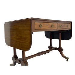 George III mahogany sofa table, rectangular drop-leaf top with reed moulded edge and rounded corners, fitted with two frieze drawers and two opposing false drawers, quadruple collar turned pillar supports on turned and block platforms, splayed and moulded supports with brass cups and castors 