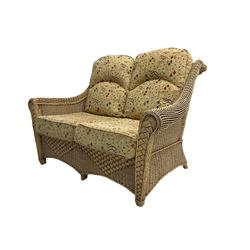 Four piece cane conservatory suite - two seat sofa (W130cm), pair of armchairs (W85cm), and coffee table (85cm x 60cm)