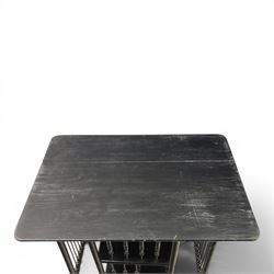 Edwardian black painted side table with incorporated revolving bookcase, supported on barley twist legs