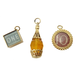  Three 9ct gold charms, two currency and an orange glass one, all hallmarked  