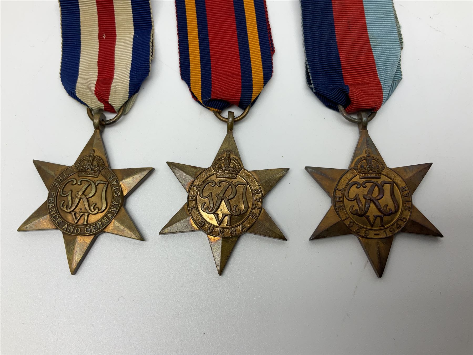 Ten WW2 medals comprising two 1939-1945 war medals, two Defence medals, two 1939-1945 Stars, two Africa Stars, France & Germany Star and Burma Star; together with bar of four miniature medals; all with ribbons