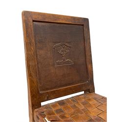 Mouseman - circa. 1930s set of six (4+2) oak dining chairs, panelled back carved with the Bagshawe family crest, the moto 'Forma Flos Fama Flatus' over an arm grasping a bugle-horn with ribbon tie and Yorkshire rose motif, adzed frame, leather lattice strap seat, on octagonal supports united by stretchers, two carvers and four side chairs, each carved with mouse signature, by Robert Thompson of Kilburn 

Provenance: Owned since manufacture by the Bagshawe family, descendants of the Staithes Group Artist Joseph Richard Bagshawe RBA (1870-1909).