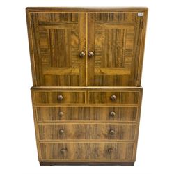 Early 20th century Art Deco walnut cocktail tallboy chest, fitted with double cupboard enclosing two shelves over two short and three long drawers, each with shell shaped handes