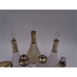 Group of early 20th century and later cut glass bottles, jars and casters, each with silver collars or covers, all stamped or hallmarked 