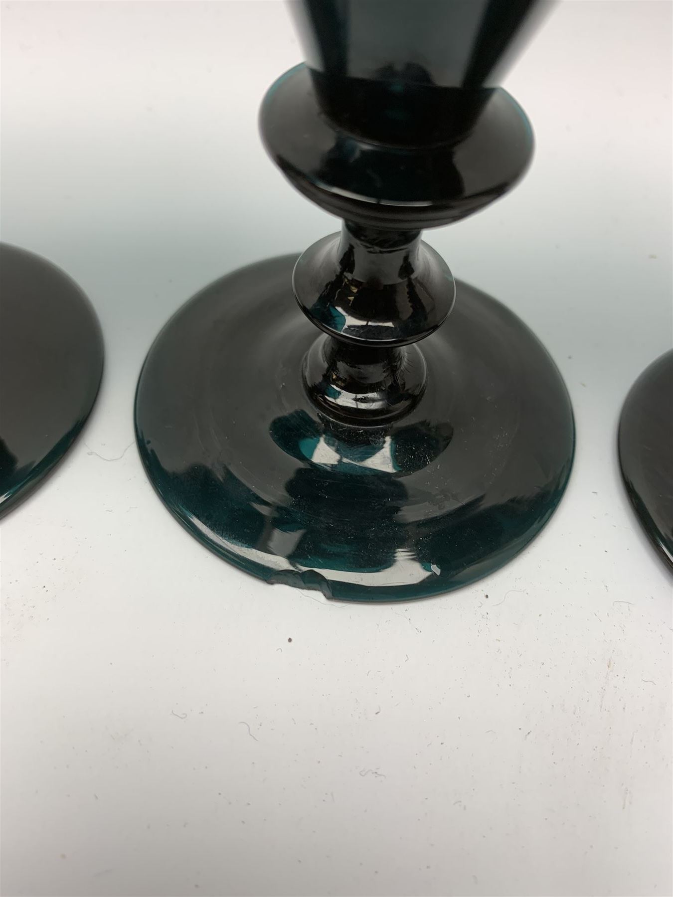 19th century green glass ships decanter with flat topped stopper, H21.5cm, together with a set of four 19th century green glass wine glasses, the funnel bowls upon bladed knopped stems and circular feet, H13cm