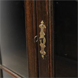 Early 20th century Jacobean Revival dark stained oak dresser, the associated upper section enclosed by twin glazed doors with shaped moulded glazing bars, over separate base fitted with two drawers, raised on bobbin turned legs