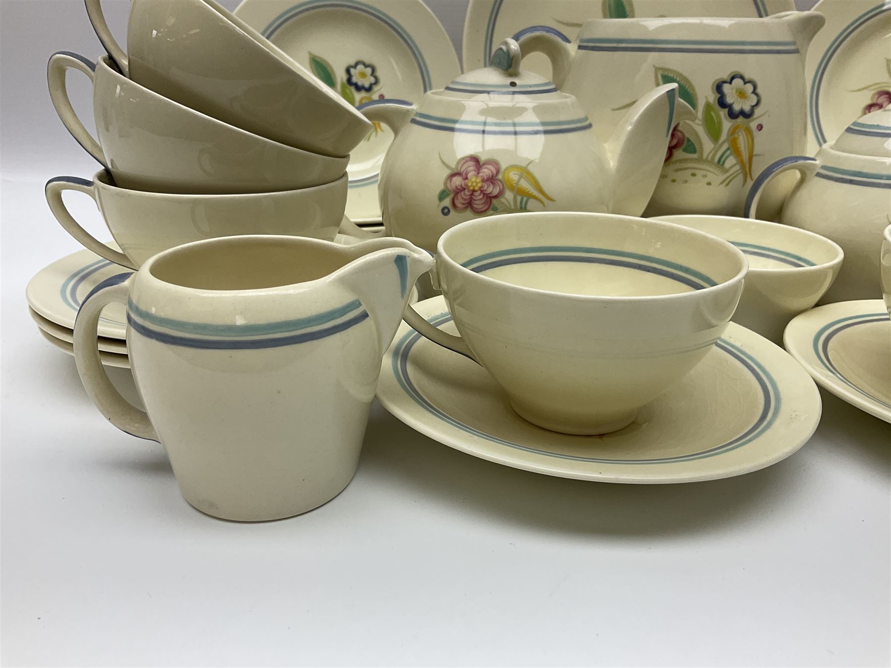 Susie Cooper Nosegay pattern tea service, teapot, eight cups and saucers, six dessert plates, three graduating jugs, covered twin handled sucrier, open sucrier  and cake plate 