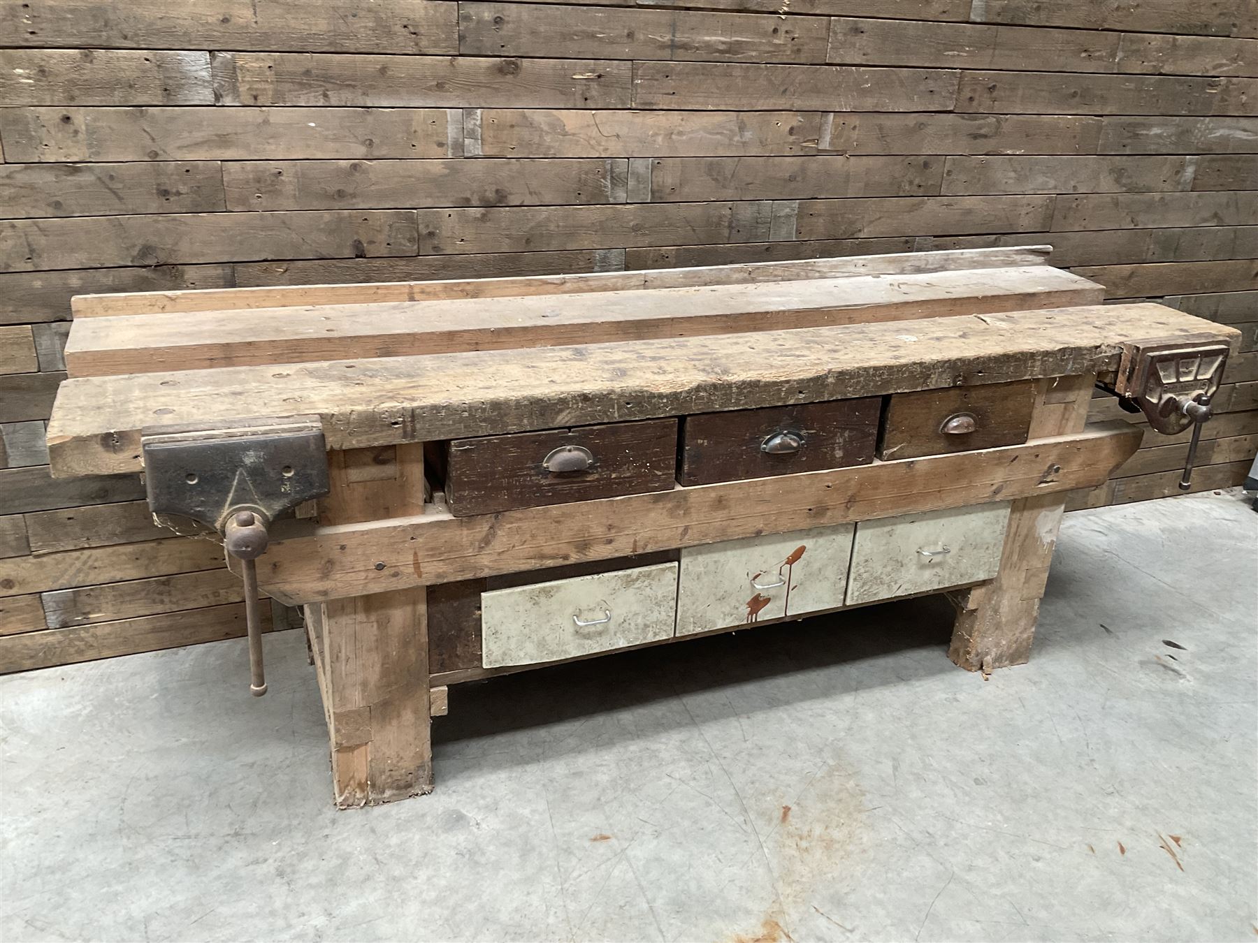 Large vintage work bench, fitted with six drawers and two vice