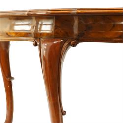 Dutch design figured walnut extending dining table, the shaped circular extending top with book-matched veneer and moulded edge, shaped banded frieze over scroll-moulded lower rail, raised on C-scroll carved cabriole supports with pad feet, with additional leaf