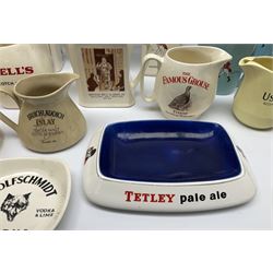 Collection of ceramic pub jugs and ashtrays, including Senior Service ashtray, Bell's old scotch whiskey ashtray,Arthur Bell & sons jug, Beefeater gin jug, two Black and White scotch whiskey jugs, etc    