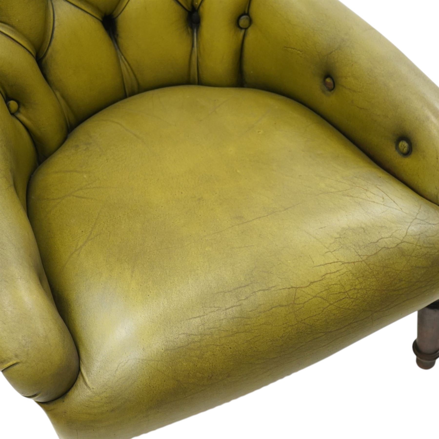 Victorian design tub armchair upholstered in buttoned green leather, on turned front supports