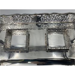 Edwardian silver desk stand, of rectangular form with scrolling pierced gallery, and pen recess before two silver mounted cut glass inkwells, upon four hoof feet, hallmarked Thomas Bradbury & Sons, London 1902, including inkwells H11cm W36cm D22cm