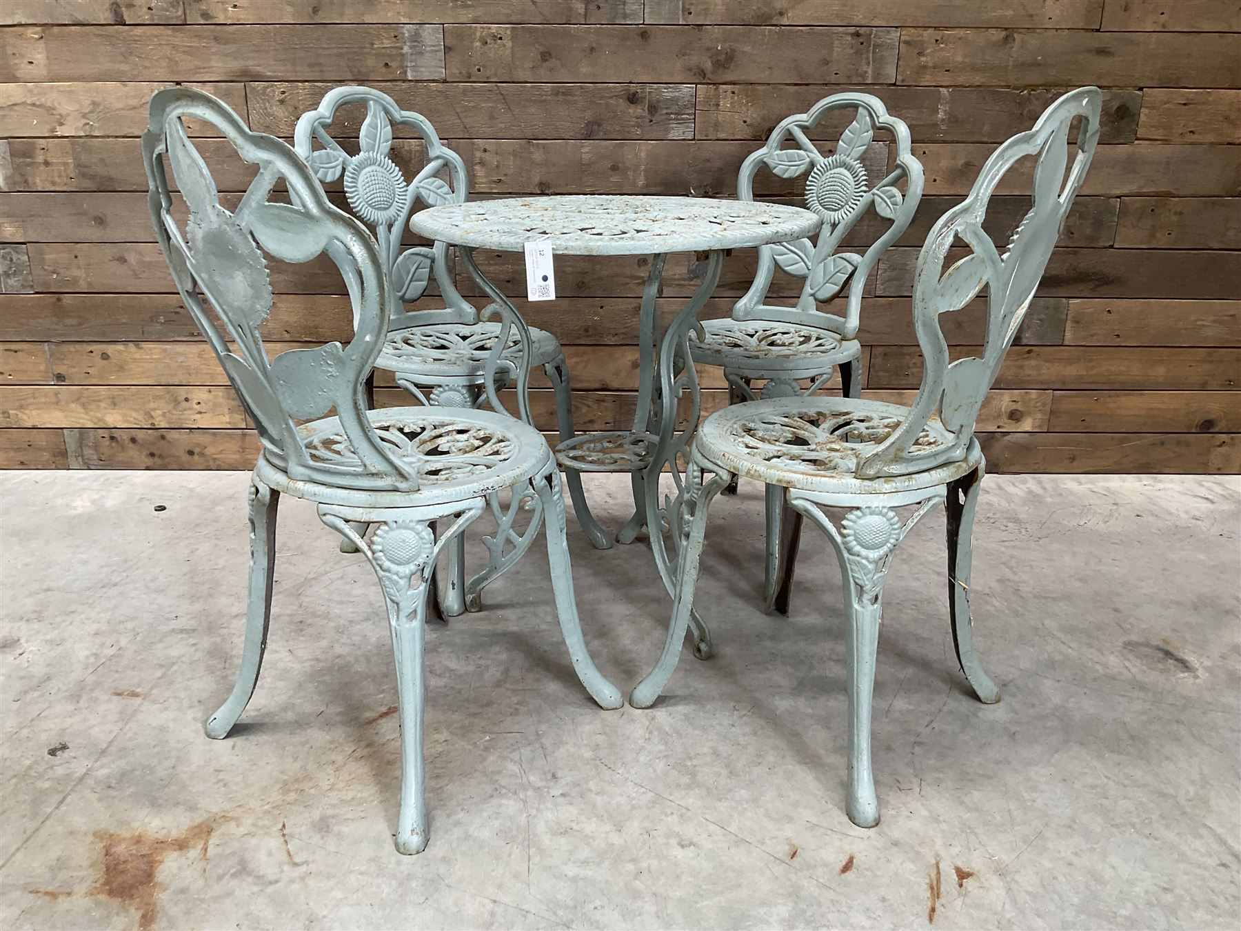 Victorian design cast alloy circular garden table and four cast iron chairs, green painted