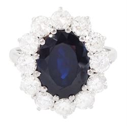 18ct white gold sapphire and diamond cluster ring, single oval cut sapphire of approx 4.50...