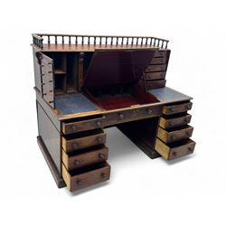 Large Victorian mahogany Registry/Dickens’ desk, spindle gallery top, one side with five small drawers and the other with blind cupboard drawer, revealing pigeon holes with scroll carved locking side bars on either side, above a hinged and leathered writing slope with three drawers and pigeon holes underneath, above a central locking drawer with key, the pedestals each with four drawers and  turned knob handles, separates into four parts for transport