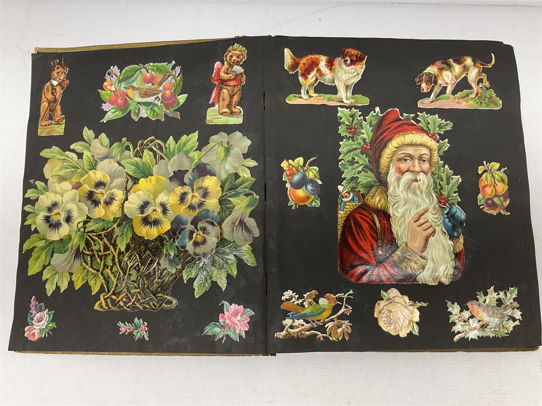 Victorian scrapbook containing twenty-six double sided pages and two fixed end pages of various fixed decoupage to include clippings of maritime interest, greeting cards, portraiture, flowers, animals etc, 