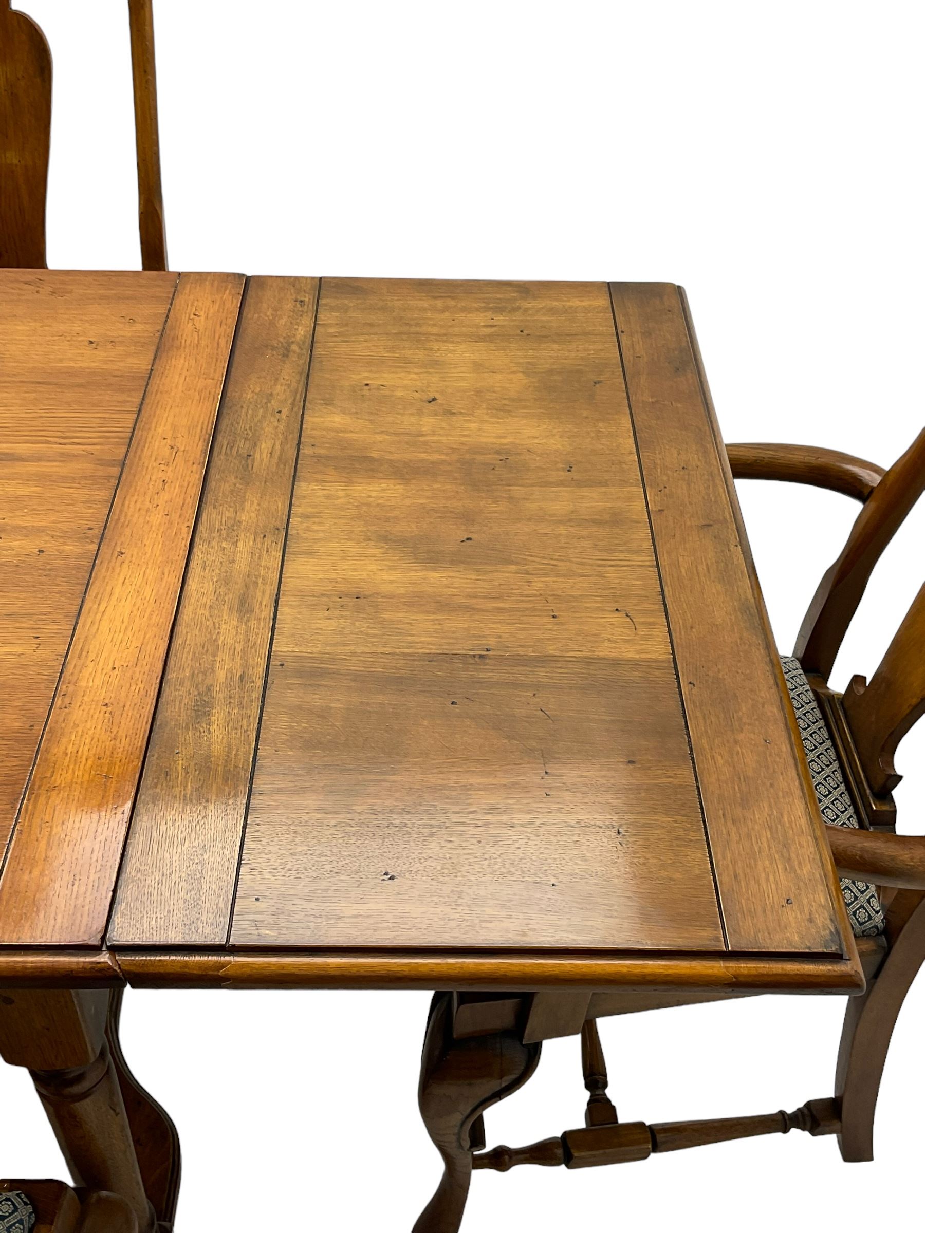 Late 20th century oak dining table, rectangular top with two draw leaf extensions, on turned supports united by moulded hayrake stretchers (180cm - 278cm x 90cm, H76cm); set of eight (6+2) oak dining chairs, shaped cresting rail over shaped splat back, upholster drop-in seat, on cabriole supports united by turned H-shaped stretchers 