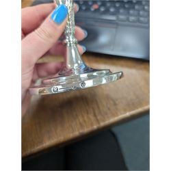 Pair of continental silver candlesticks, probably German Hanau, each of tapering form, with fern leaf decoration, upon a stepped circular base, with Hanau marks and assay scrape to base, H19cm