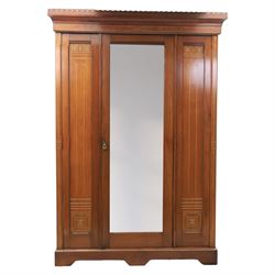 Aesthetic Movement walnut parcel gilt wardrobe, the crenellated top, above central mirrore...