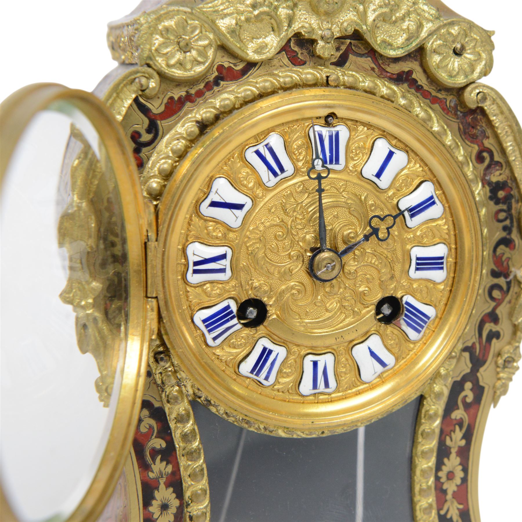 Louis XV-style gilt-bronze mounted turtleshell boulle mantel clock, the case of typical waisted form, gilt bronze foliate scroll and rocaille mounts, raised on scroll feet. Eight-day Paris movement signed “Rollin à Paris”, with outside count-wheel striking half-hourly on a single bell, the going train with anchor escapement. The circular foliate gilt bronze dial with enamelled Roman hour numerals and twin winding apertures, fitted with pierced blue steel hands and bevelled glass cover, with pendulum and key, circa 1860