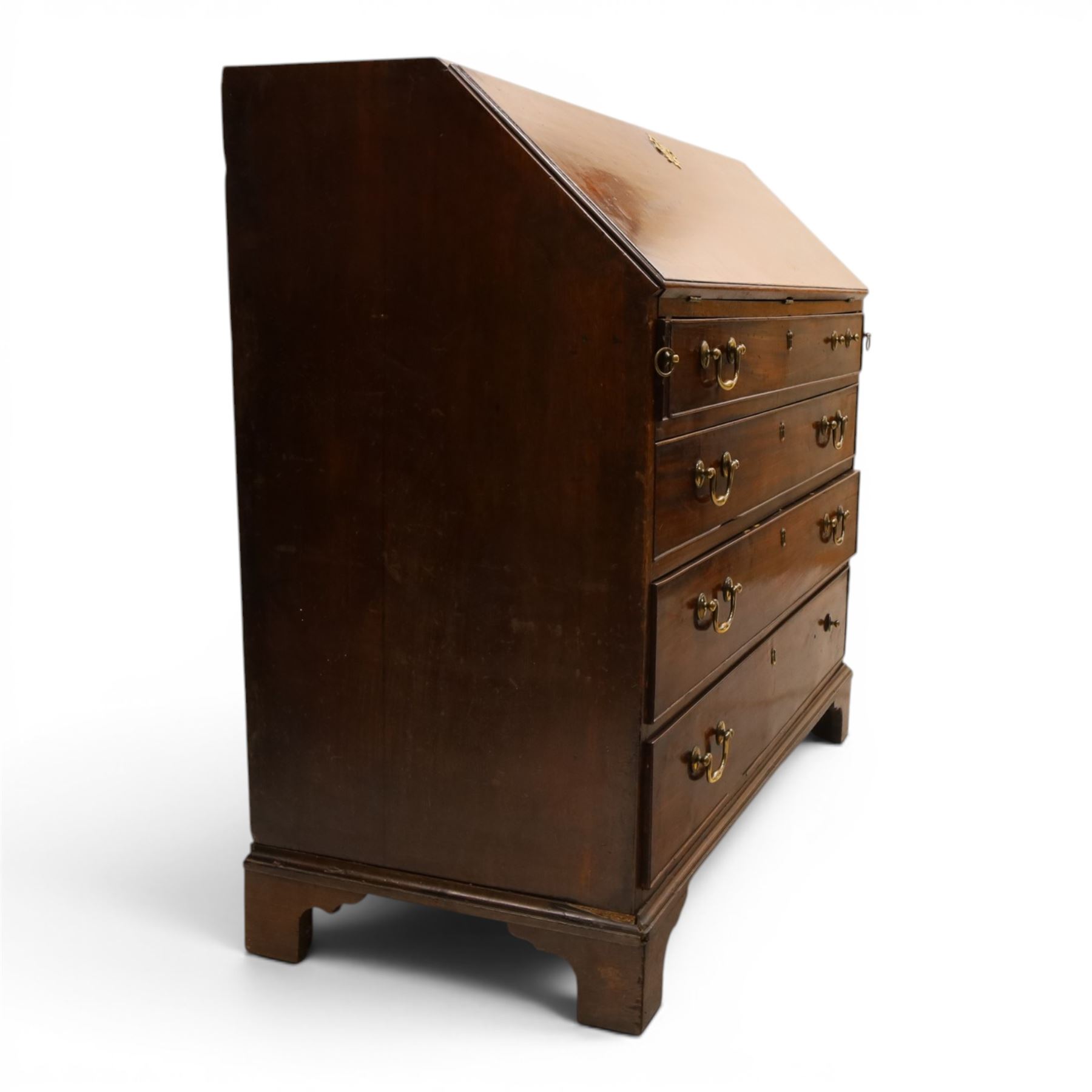 George III mahogany bureau of large proportions, the fall-front enclosing fitted interior with fluted column secret compartments and assorted pigeonholes and correspondence drawers flanking central cupboard, over four graduating cock-beaded drawers with original brass swan-neck handles, raised on bracket feet