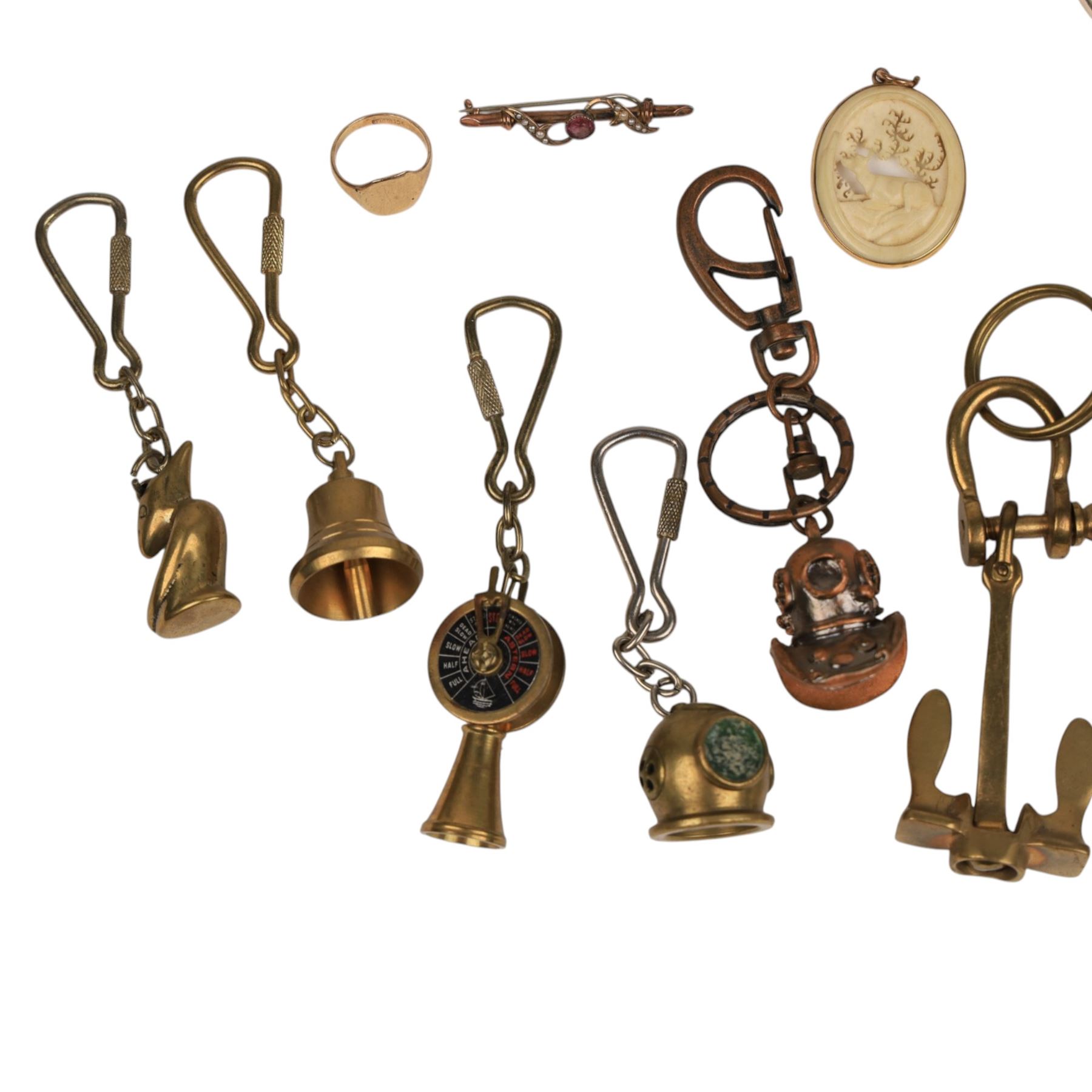 9ct gold jewellery, including bone deer pendant in gold mount, signet ring and stone set brooch, all stamped or hallmarked, three silver bangles, base metal bangle, brass diving related keychains and a Tag Heuer quartz wristwatch