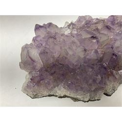 Amethyst crystal geode cluster, with well-defined crystals of various sizes, H10cm, L30cm