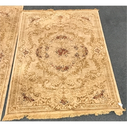  Pair graduating Persian style gold ground rugs central medallion, repeating border, 293cm x 193cm and 227cm x 155cm mao0207  
