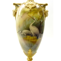  Royal Worcester porcelain twin handled pedestal vase, painted with two wading storks in a misty woodland landscape, signed by Arthur Lewis, within gilded acanthus leaf and scroll borders, mask handles below garland wreaths and scrolled panelled neck, shape number 1410, date code for 1909, H39cm   