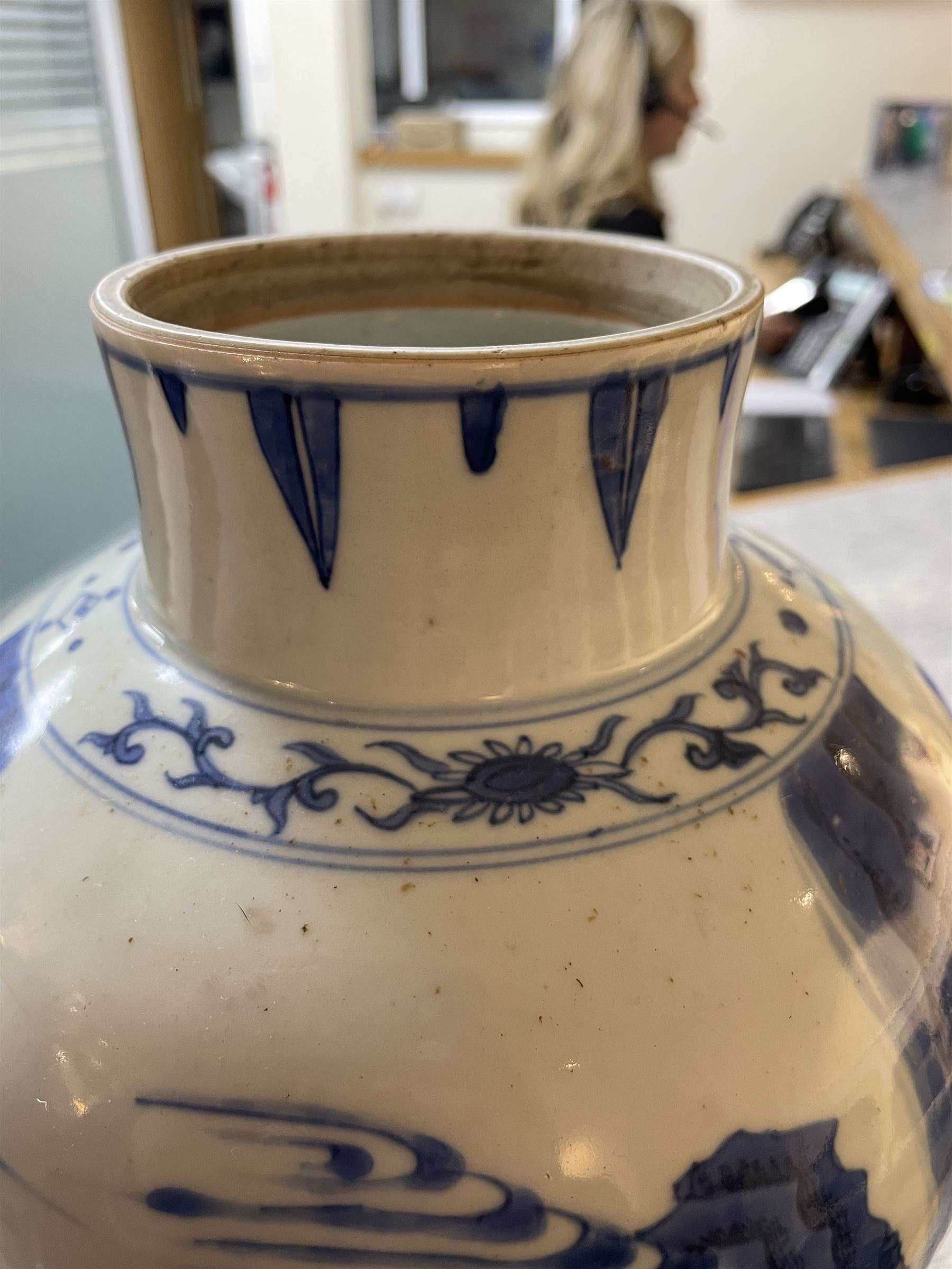 Pair of Chinese Kangxi blue and white porcelain vases, each of baluster form, painted with an outdoor scene containing figures seated upon the ground reading scrolls and holding fans, willow and bamboo tress, rock work and water, H27cm