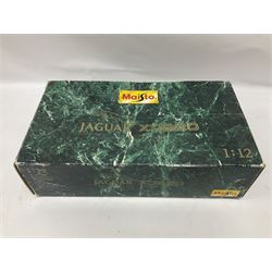 Two Maisto 1:12 scale Jaguar XJ220 ‘Racing’ cars in yellow, both on plinths in original boxes 