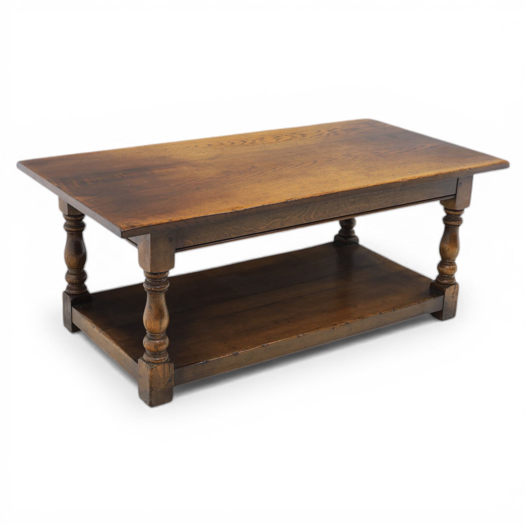 Oak coffee rectangular table, in the manner of Titchmarsh & Goodwin, raised on turned supports united by a full length undertier