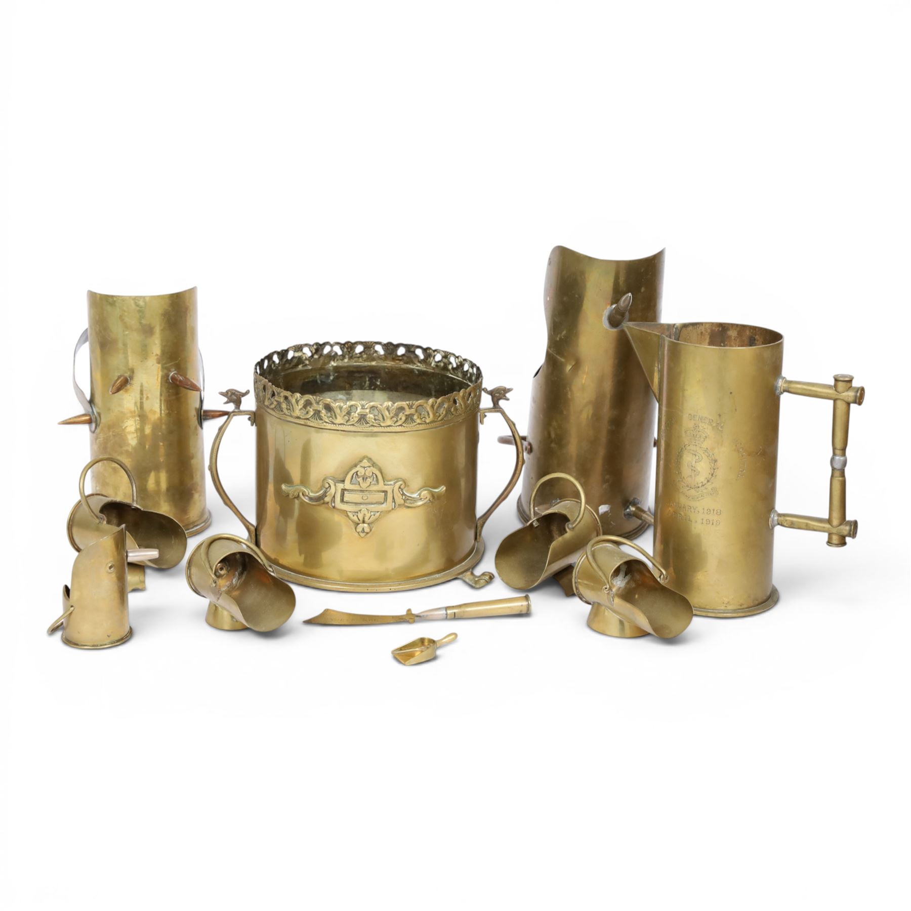 Trench Art shell case jardiniere, with pierced rim and paw feet, Jug marked The British General Hospital  January 1918 April 1919, seven miniature coal buckets and a sword   