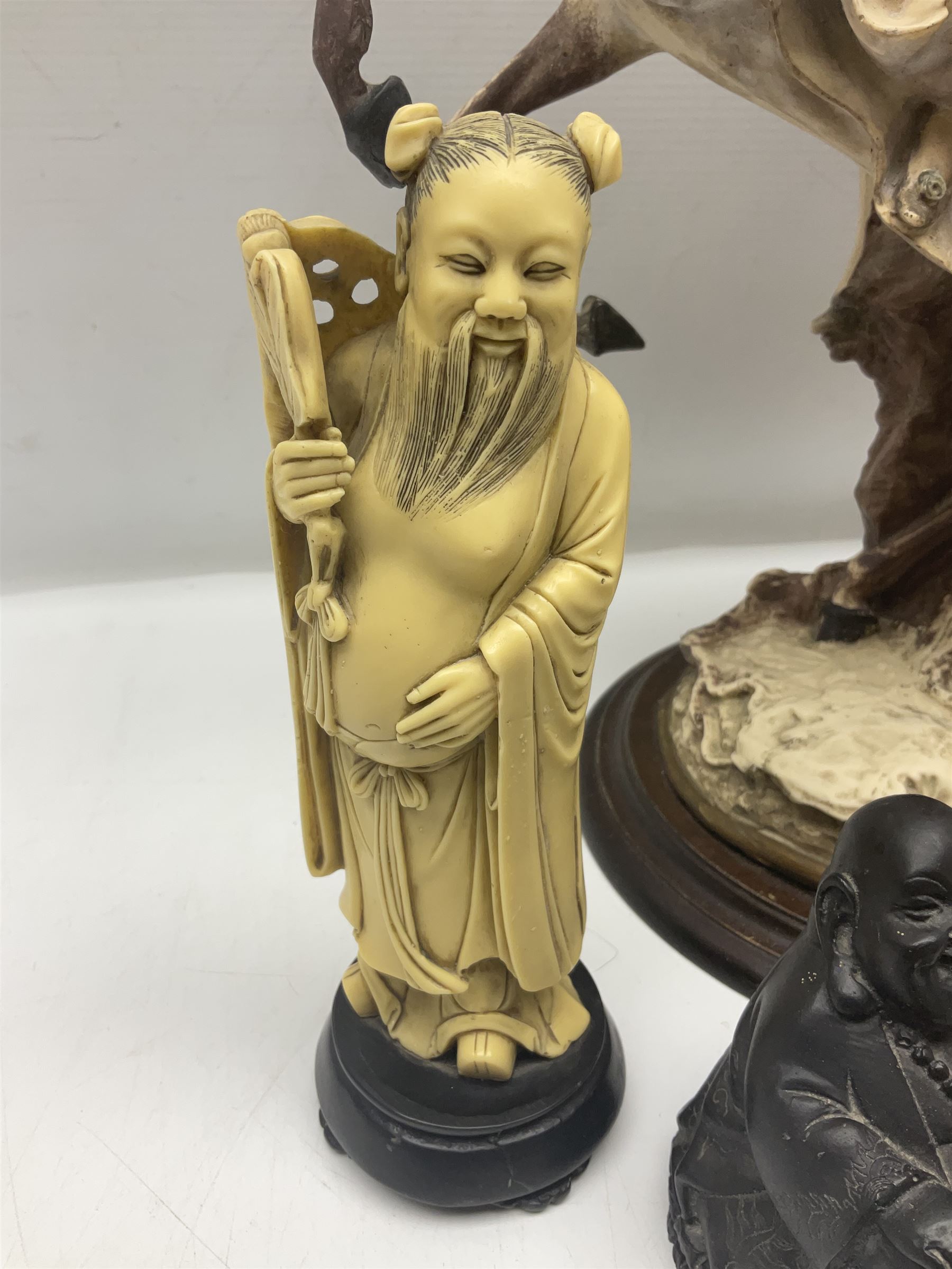 Composite figure of a couple upon a rearing horse, together with a collection of resin immortals and two bone chests 