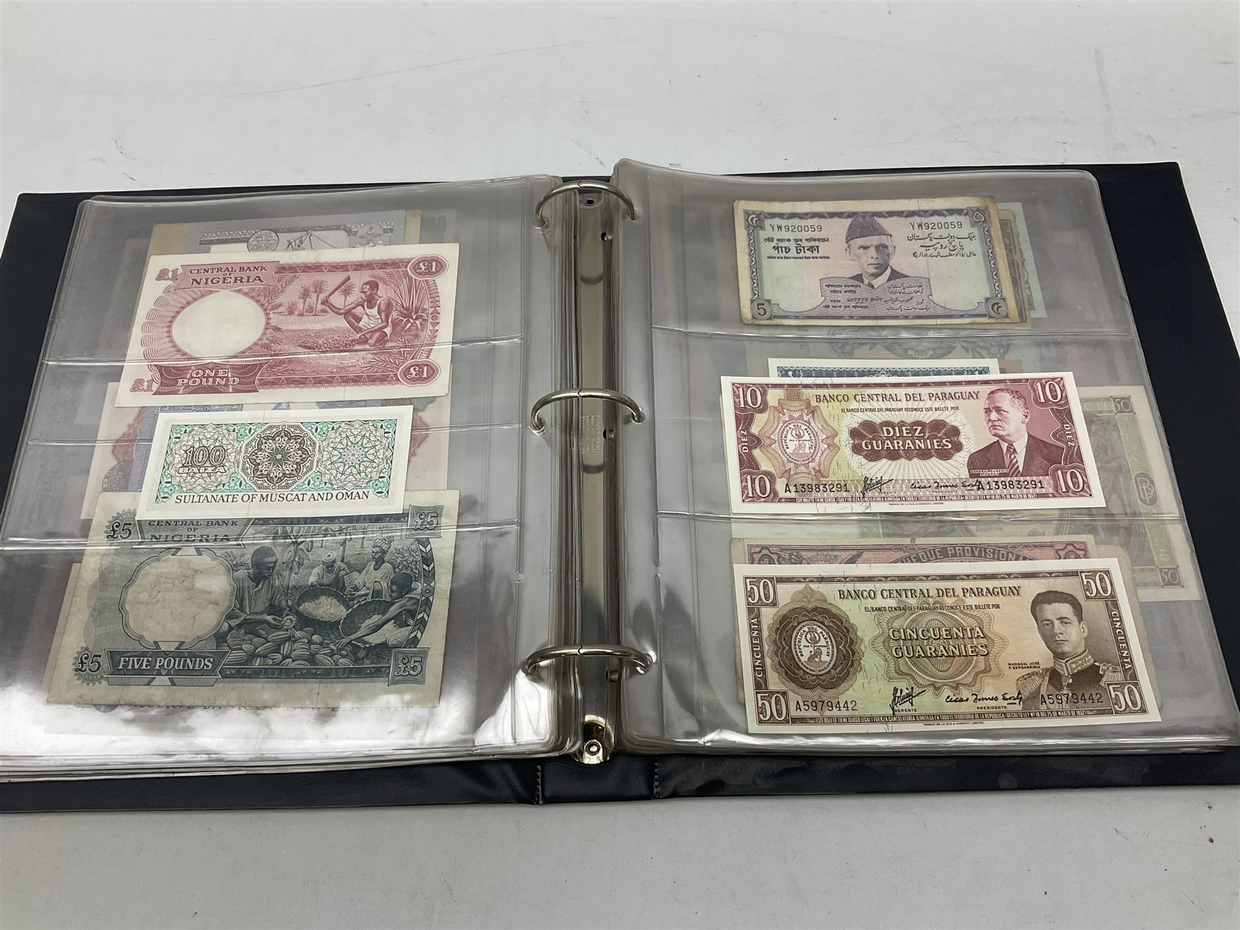 World banknotes, including Queen Elizabeth II The States of Jersey one pound 'DB202703', five pounds 'BB527762' and ten pounds 'AB651481', reserve bank of New Zealand two dollars '1L3 741894', King George V Straits Settlements one dollar 1st January 1935 'F/83 28924', various Bank of England notes etc, housed in two ring binder albums