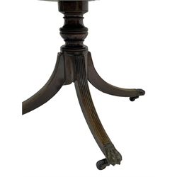 George III mahogany breakfast table, the oval top with a kingwood band and boxwood stringing, raised on a turned vasiform pedestal terminating in a fluted sabre tripod base with hairy paw feet and castors