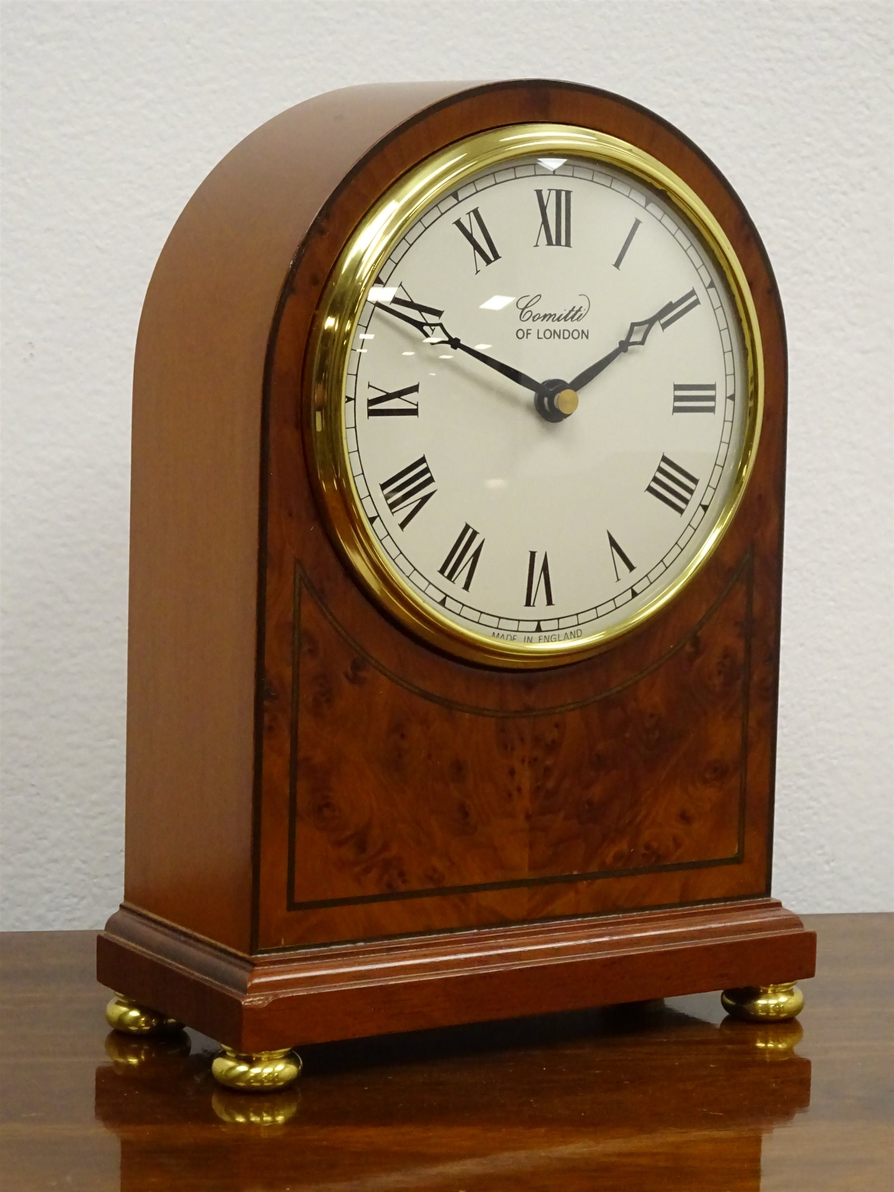 Comitti walnut cased arched top mantel clock, brass bezel and ball feet, No.C009Q, quartz