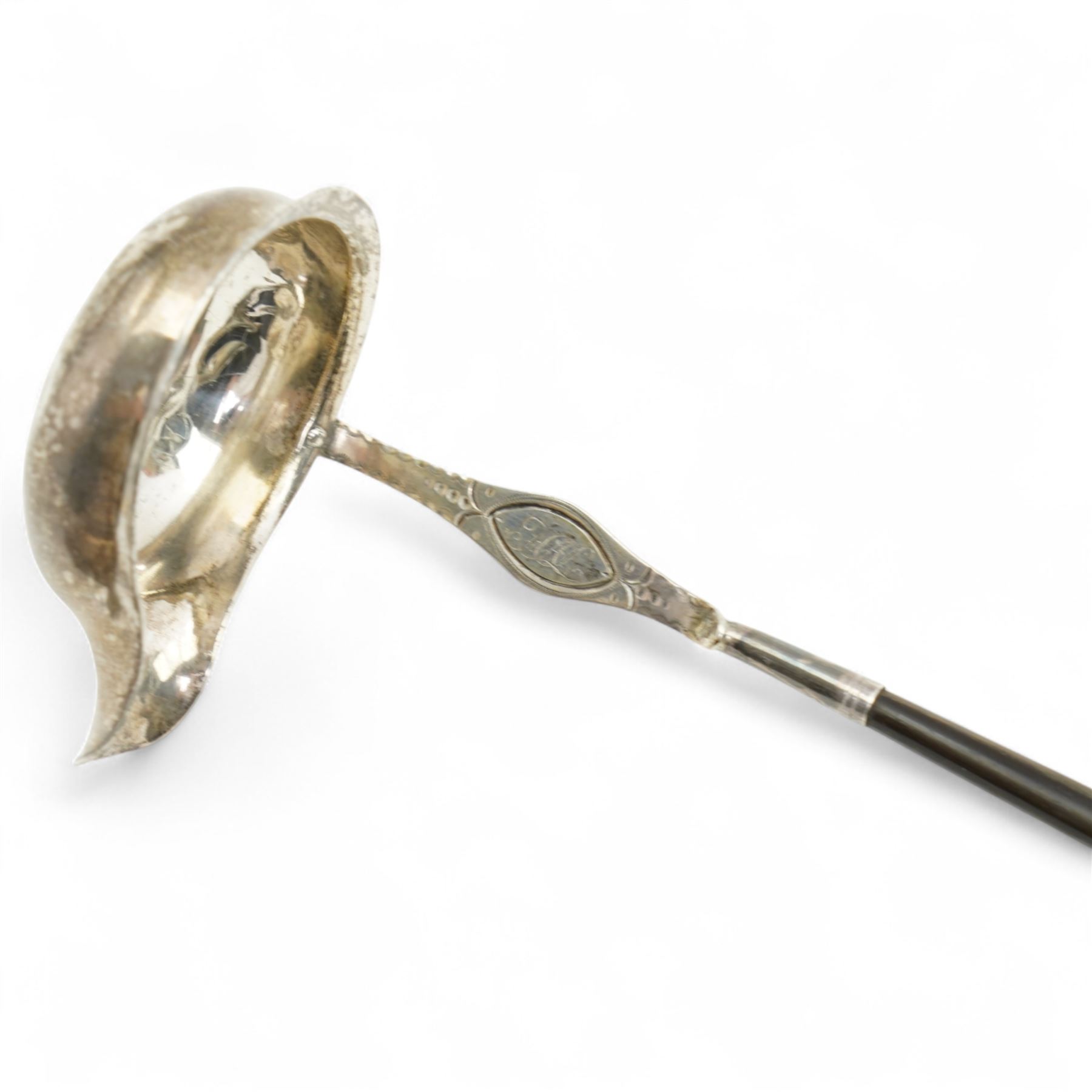 Early 19th century silver punch ladle, the bowl inset with a George III coin and with twisted whale bone handle,, plated wine funnel, two knives by John Wigfall, Sheffield with mammoth tooth handles, plated coaster with engraved crowned anchor crest, teapot stand with brass centre and plated surround and a pair of sugar tongs  