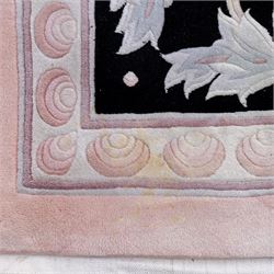 Large late 20th century Aubusson style wool carpet, peach and pastel toned field with central floral medallion enclosing scrolling acanthus and and foliate sprays, surrounding field decorated with further stylized foliage and and floral ornament, within shaped reserves and indigo corner spandrels, enclosed by narrow guard border, cotton fringe ends