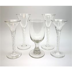 Four 20th century drinking glasses in the 18th century taste with funnel bowls upon mercury twist stems, tallest H17.5cm, together with a Victorian rummer with slice cut stem, H15.5cm