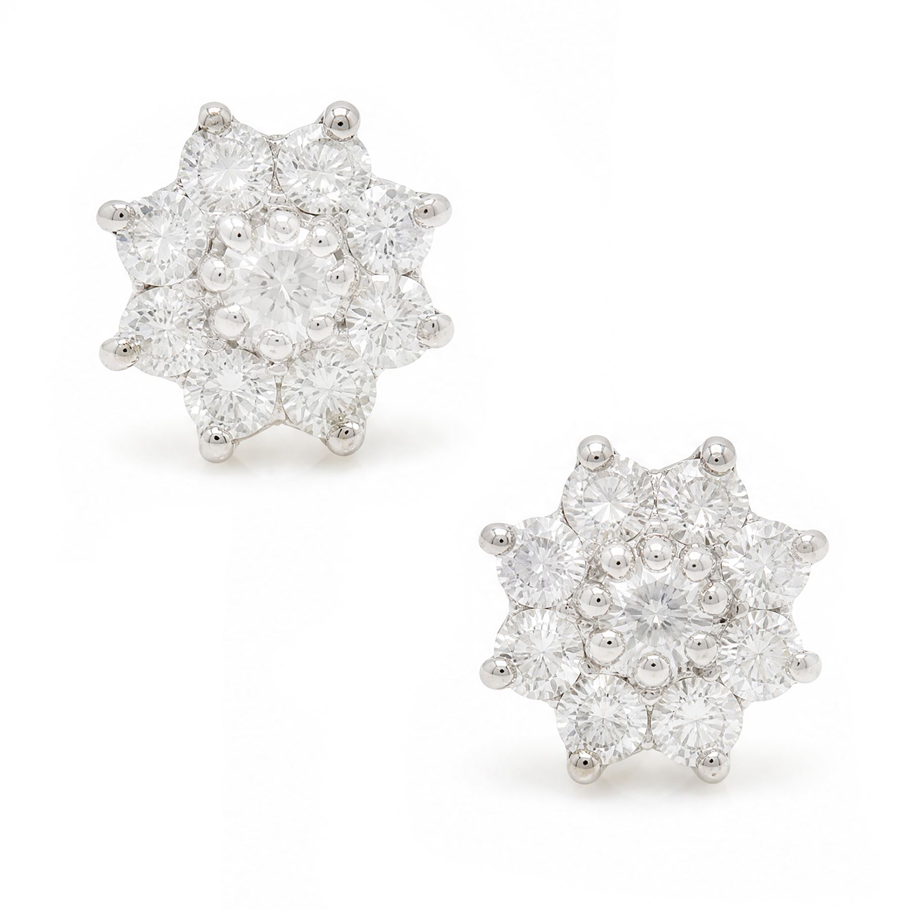 Pair of 18ct white gold diamond flower head earrings, each stud set with nine round brilliant cut diamonds, Birmingham 1996, total diamond weight approx 1.20 carat