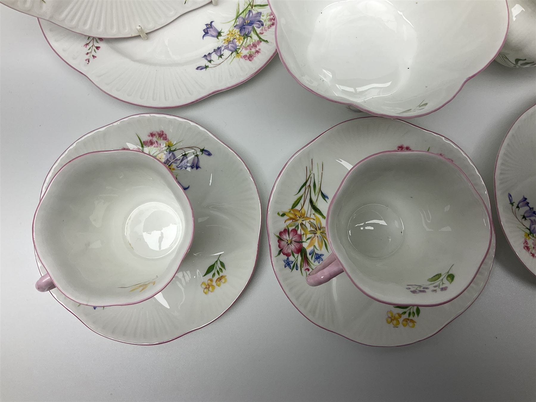 Shelley Wild Flowers pattern part tea service, comprising four cups and saucers, four dessert plates, cake plate, milk jug and open sucrier