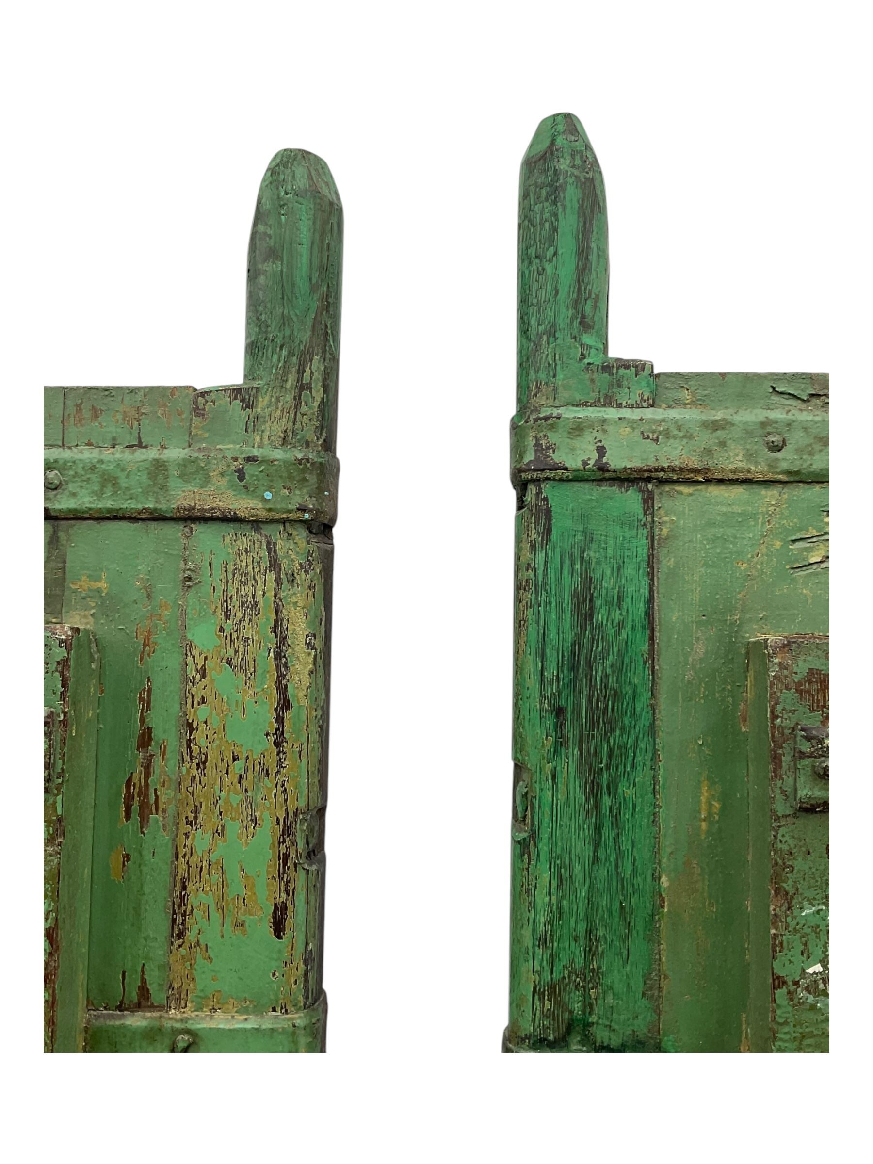 Pair of green-painted Indian doors, c.1860–1880, made from solid teak featuring original iron work and hand-painted finish