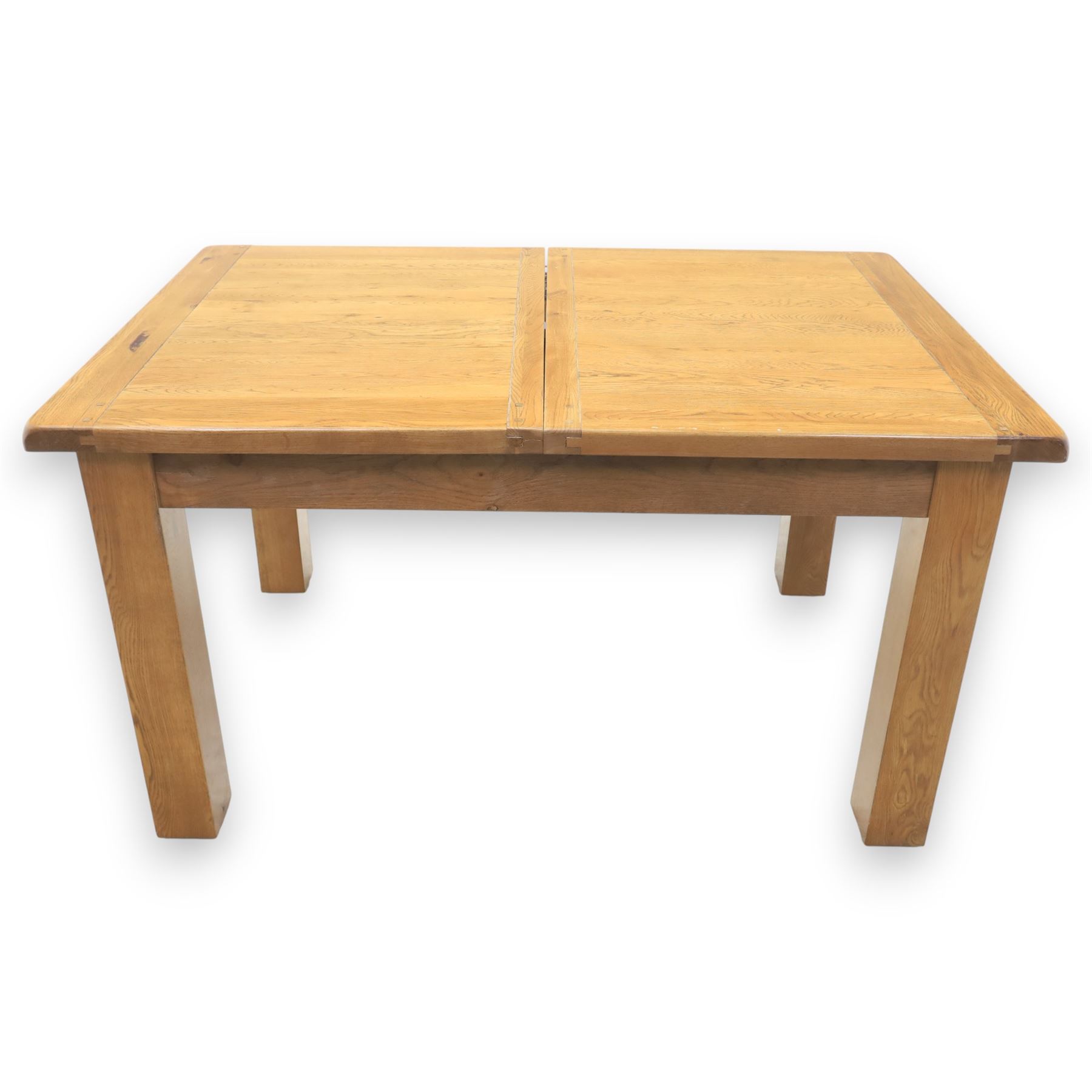 Contemporary oak extending dining table, moulded rectangular top with visible grain and inset extension leaf, pull out extending mechanism, standing on four square legs, accompanied by a set of high slat back chairs with upholstered brown faux leather seats and square tapering supports joined by stretchers