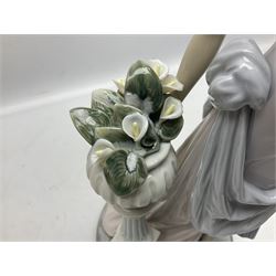 Four Lladro figures, comprising Touch of Class no 5377, Boy Student no 4517, Ocean Beauty no 5785 and Carnival Couple no 4882, largest example H45cm