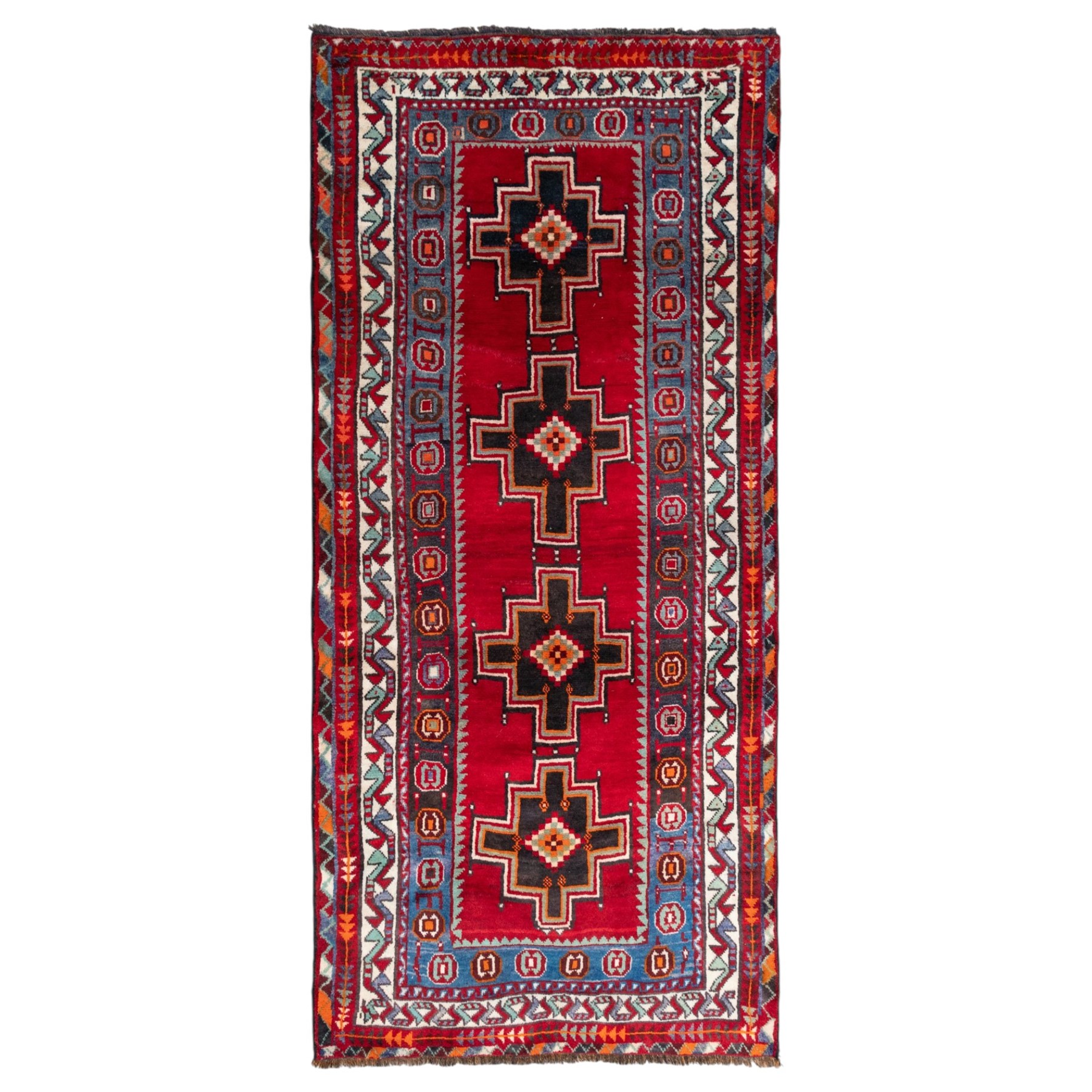 South-west Persian Lori rug, the red field centred by four linked stepped cruciform medallions with polychrome diamond centres, enclosed by a blue ground octagonal motif border, ivory angular meander band and red geometric outer border