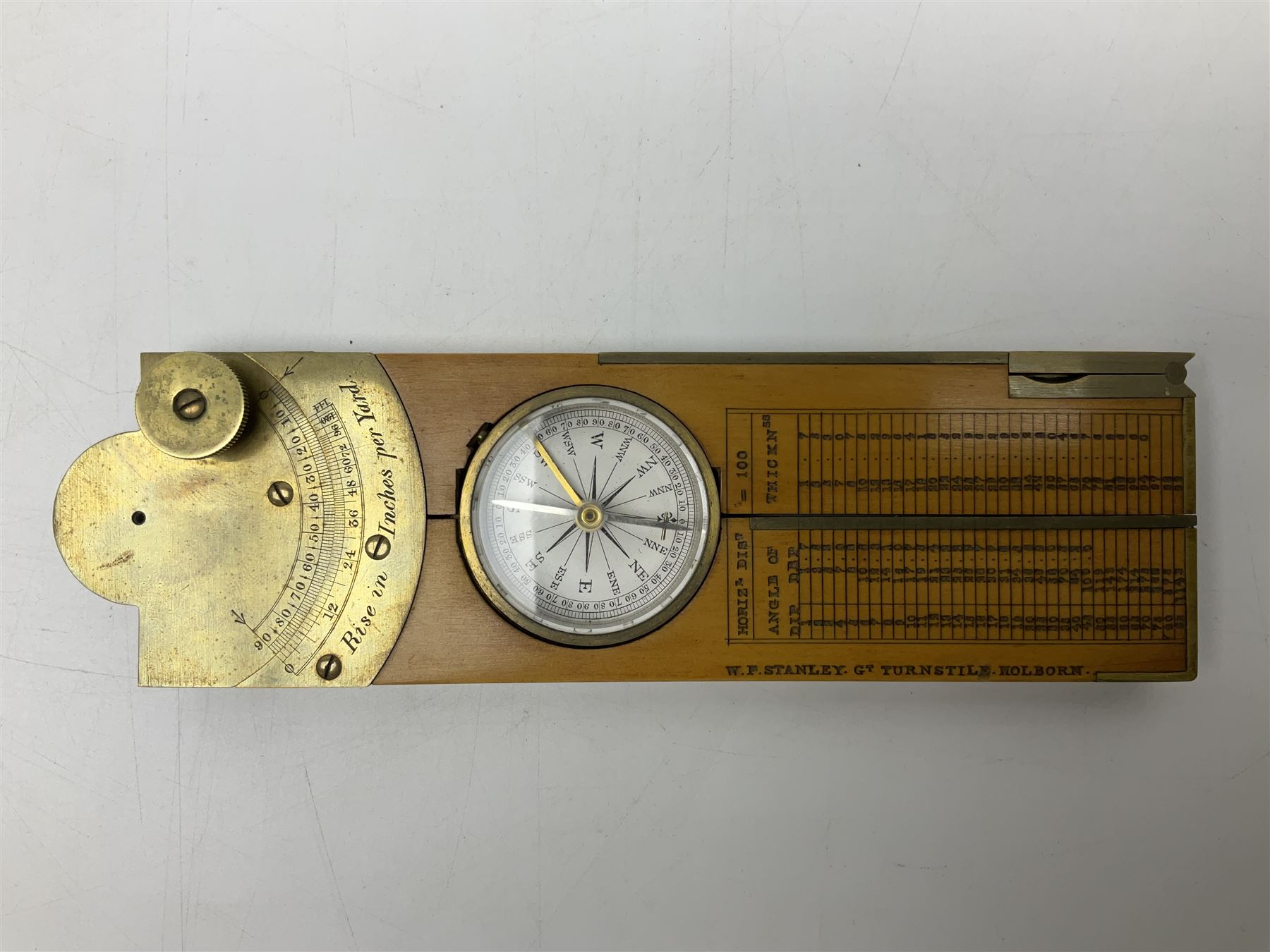 Late 19th/early 20th century boxwood and brass clinometer rule by Stanley, with inset magnetic compass, screw action protractor hinge divided to one degree with rise in inches per yard scale under, spirit level to one edge, marked 'W.F. Stanley Great Turnstile Holborn' with tables of distances, angles and thickness H16cm closed: in original leather covered case with instructions
